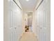 Hallway with built-in double closets and neutral wall colors at 8086 Sw 81St Loop, Ocala, FL 34476