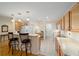 Kitchen with island, breakfast bar, and light wood cabinets at 8086 Sw 81St Loop, Ocala, FL 34476