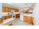 Bright kitchen with white appliances, wood cabinets, and island at 8086 Sw 81St Loop, Ocala, FL 34476