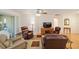 Spacious living room with hardwood floors, comfortable seating, and access to a patio at 8086 Sw 81St Loop, Ocala, FL 34476