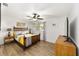 Comfortable bedroom with a wooden bed frame, and a side table at 8580 Sw 97Th Lane Rd # B, Ocala, FL 34481