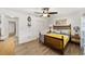 Bright bedroom with wood-framed bed, ceiling fan, and tiled floors at 8580 Sw 97Th Lane Rd # B, Ocala, FL 34481