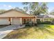 Front view of a house with a two-car garage and well-maintained lawn at 8580 Sw 97Th Lane Rd # B, Ocala, FL 34481