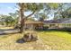 House exterior with a large tree and a rock in the front yard at 8580 Sw 97Th Lane Rd # B, Ocala, FL 34481