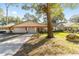 House exterior showcasing a two-car garage and lush landscaping at 8580 Sw 97Th Lane Rd # B, Ocala, FL 34481