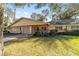 Inviting single-story home with an attached garage, complemented by a beautifully maintained lawn and mature trees at 8580 Sw 97Th Lane Rd # B, Ocala, FL 34481
