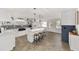 Modern white kitchen with a farmhouse sink and breakfast bar at 8580 Sw 97Th Lane Rd # B, Ocala, FL 34481