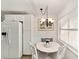 White kitchen features a breakfast nook and a chandelier at 8580 Sw 97Th Lane Rd # B, Ocala, FL 34481