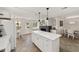 Open concept kitchen with large island, white cabinets, and fireplace at 8580 Sw 97Th Lane Rd # B, Ocala, FL 34481