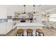 Modern kitchen with white cabinets, quartz counters, and stylish backsplash at 8580 Sw 97Th Lane Rd # B, Ocala, FL 34481