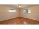 Spacious bedroom with hardwood floors and ceiling fan at 8653 Sw 96Th St # A, Ocala, FL 34481