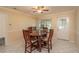Dining room with tile floor, wood table and chairs, and access to outside at 8653 Sw 96Th St # A, Ocala, FL 34481