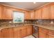Updated kitchen featuring wood cabinets, granite countertops, and stainless steel appliances at 8653 Sw 96Th St # A, Ocala, FL 34481