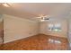 Spacious living room featuring hardwood floors and ceiling fan at 8653 Sw 96Th St # A, Ocala, FL 34481