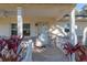 Front porch with white columns, ceiling fan, and door at 8653 Sw 96Th St # A, Ocala, FL 34481