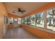 Bright sunroom with tile floors, ceiling fan, and multiple windows at 8653 Sw 96Th St # A, Ocala, FL 34481