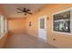 Sunroom features tile flooring, a ceiling fan, and access to the backyard at 8653 Sw 96Th St # A, Ocala, FL 34481