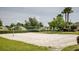 Outdoor sand volleyball court with a net and surrounding green space at 9811 Se 138Th Loop, Summerfield, FL 34491