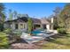 Spacious backyard with a pool and spa, surrounded by mature trees at 995 Sw 37Th Place Rd, Ocala, FL 34471