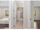 Bright bathroom with an open doorway to a shower with curtain at 995 Sw 37Th Place Rd, Ocala, FL 34471