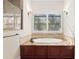 Bathroom with soaking tub and window with shutters at 995 Sw 37Th Place Rd, Ocala, FL 34471