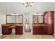 Double vanity bathroom with granite countertops and rich wood cabinets at 995 Sw 37Th Place Rd, Ocala, FL 34471