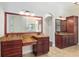 Elegant bathroom boasts double vanities, granite counters, and large mirror at 995 Sw 37Th Place Rd, Ocala, FL 34471