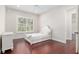 Bright bedroom with hardwood floors and white furnishings at 995 Sw 37Th Place Rd, Ocala, FL 34471
