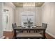 Well-appointed dining room with wainscoting, designer lighting, and views of the landscaped yard at 995 Sw 37Th Place Rd, Ocala, FL 34471