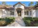 House exterior showcasing a grand entrance with columns and a charming walkway at 995 Sw 37Th Place Rd, Ocala, FL 34471