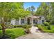 Charming stucco home featuring a brick walkway and professionally landscaped front yard at 995 Sw 37Th Place Rd, Ocala, FL 34471