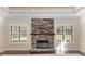 Living room with a large stone fireplace at 995 Sw 37Th Place Rd, Ocala, FL 34471