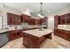 Gourmet kitchen with granite countertops, custom cabinetry, and stainless-steel appliances at 995 Sw 37Th Place Rd, Ocala, FL 34471
