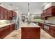 Gourmet kitchen with granite countertops, custom cabinetry, and stainless-steel appliances at 995 Sw 37Th Place Rd, Ocala, FL 34471