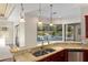 Gourmet kitchen features granite countertops, stainless steel appliances, and a view of the pool at 995 Sw 37Th Place Rd, Ocala, FL 34471