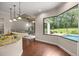 Bright kitchen with granite counters, pendant lighting, and a view of the pool at 995 Sw 37Th Place Rd, Ocala, FL 34471