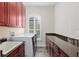Laundry room with granite counters and built-in cabinets at 995 Sw 37Th Place Rd, Ocala, FL 34471