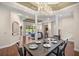 Open-concept living room with hardwood floors, a coffered ceiling, and views of the pool area at 995 Sw 37Th Place Rd, Ocala, FL 34471