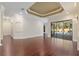 Spacious living area with hardwood floors, coffered ceiling, and pool view at 995 Sw 37Th Place Rd, Ocala, FL 34471