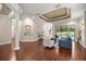 Inviting living room features coffered ceilings, hardwood flooring, and a seamless connection to other living spaces at 995 Sw 37Th Place Rd, Ocala, FL 34471
