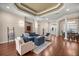 Comfortable living room featuring hardwood floors, coffered ceilings and seamless flow to other living spaces at 995 Sw 37Th Place Rd, Ocala, FL 34471