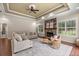 Spacious living room with tray ceiling, stone fireplace, and lots of natural light at 995 Sw 37Th Place Rd, Ocala, FL 34471