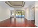 Living room with hardwood floors, coffered ceiling, and sliding glass doors at 995 Sw 37Th Place Rd, Ocala, FL 34471