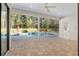 Inviting pool area with covered patio and lush landscaping at 995 Sw 37Th Place Rd, Ocala, FL 34471