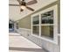 Covered porch with ceiling fan and large windows at 000 Ne 30Th Ct, Reddick, FL 32686