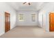 Large bedroom with carpet and two windows at 10320 Sw 103Rd Ct, Ocala, FL 34481