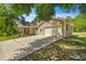 House exterior showcasing a large driveway and garage at 10320 Sw 103Rd Ct, Ocala, FL 34481