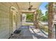 Covered front porch with stone columns and ceiling fan at 10320 Sw 103Rd Ct, Ocala, FL 34481