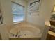 Bathroom with corner bathtub, shower, and window at 1060 Sw Big Tree Rd, Dunnellon, FL 34431