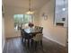 Dining room with hardwood floors and large window at 1060 Sw Big Tree Rd, Dunnellon, FL 34431